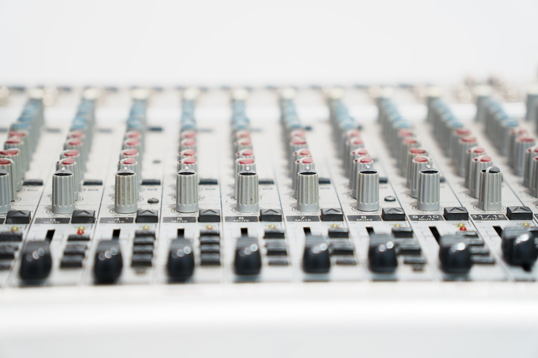 Audio mixing console with faders and knobs